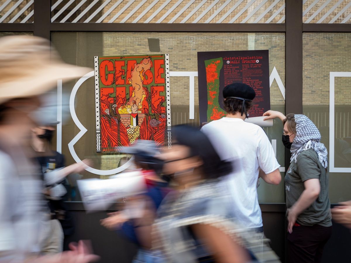 Students protesting against the war in Gaza install posters on the exterior of the School of Visual Arts in Manhattan on 2 May 2024 Photo © Carlos Chiossone / ZUMA Press Wire / Alamy Stock Photo