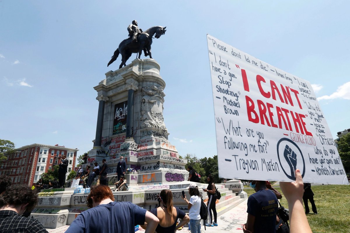 Virginia Lt. Gov. Justin Fairfax, left, speaks to protesters in front of the statue of Confederate General Robert E. Lee on Monument Avenue, in Richmond, Va. Fairfax supports the removal of the statue, which Gov. Ralph Northam said will be removed "as soon as possible" from Monument Avenue. Steve Helber/AP/Shutterstock