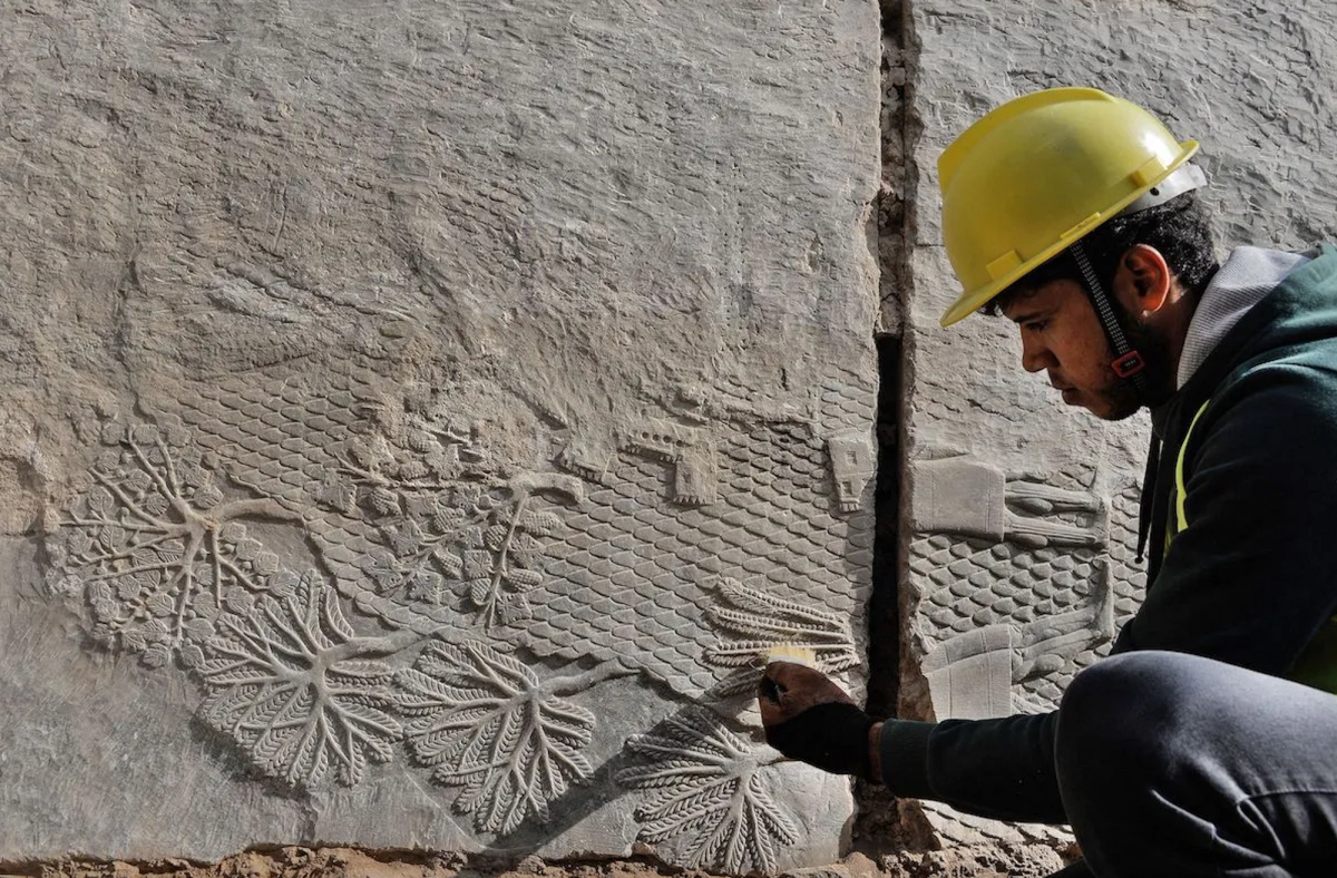 An Iraqi worker excavates a rock-carving relief recently found at the Mashki Gate. Courtesy of the Iraqi State Board of Antiquities & Heritage