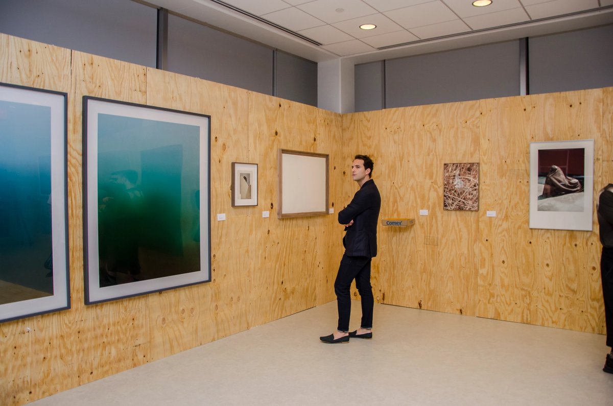 An attendee surveys the anonymous offerings at the Anónimo auction The Flacas