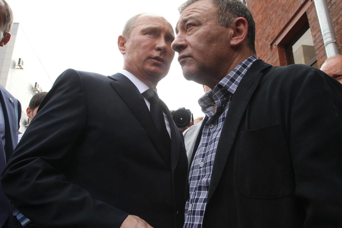 Arkady Rotenberg (right) and his brother Boris, who were named in the Senate report, are close allies of Vladmir Putin (left) Sasha Mordovets/Getty Images