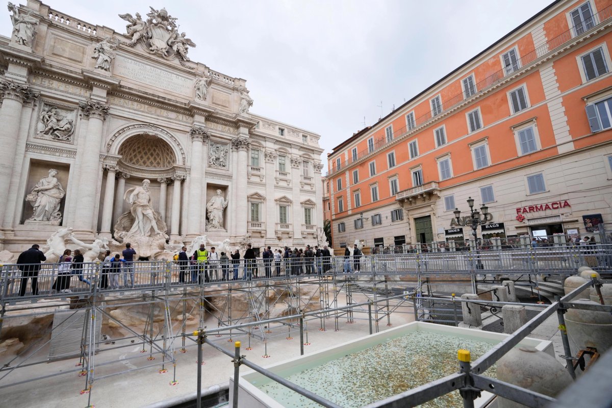 Visitors to the Trevi Fountain must use a walkway while a €300,000 conservation project is under way
AP Photo/Gregorio Borgia