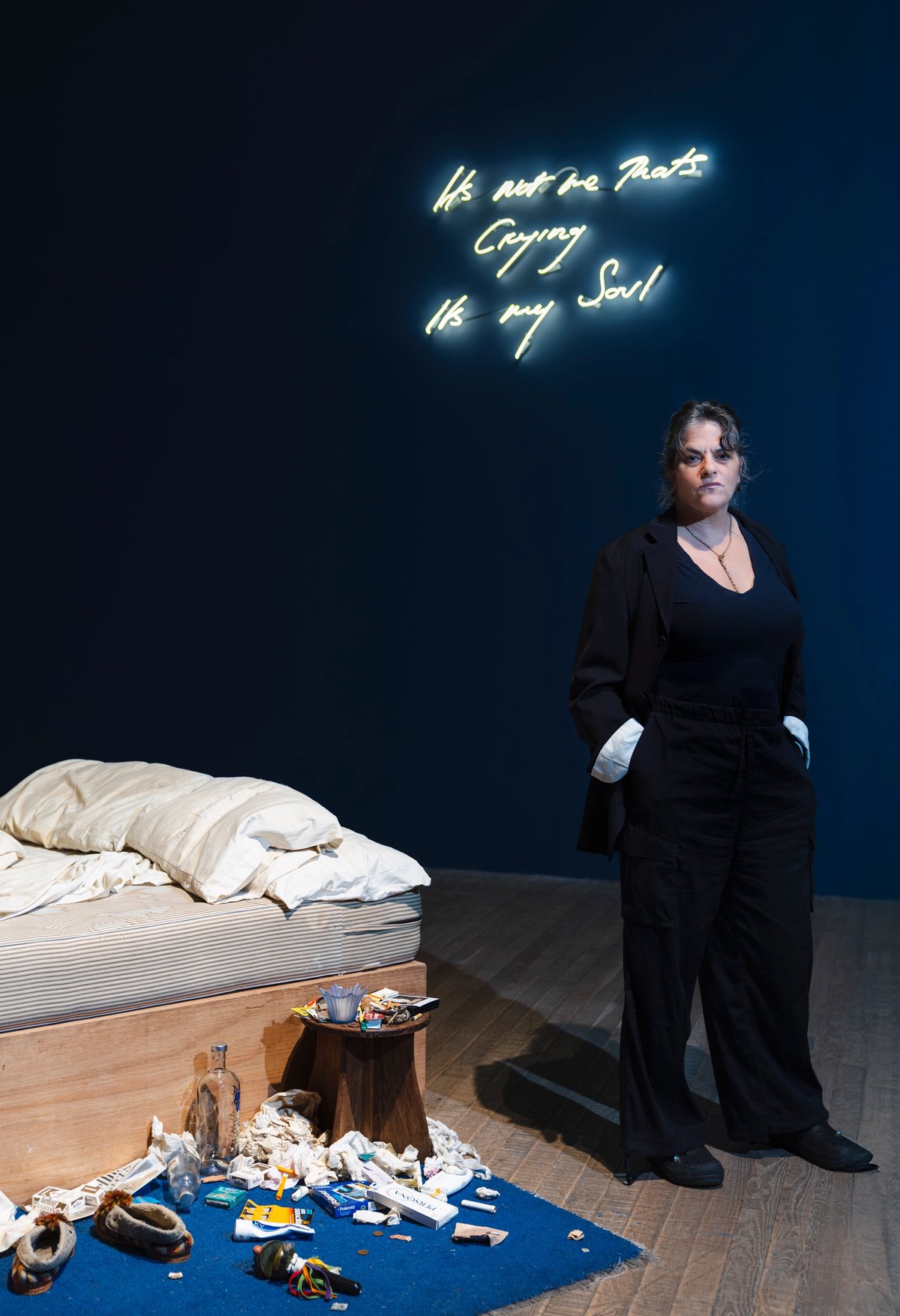 Tracey Emin standing next to My Bed, installed at her Tate Modern exhibition Second Life
© Tate / Sonal Bakrania