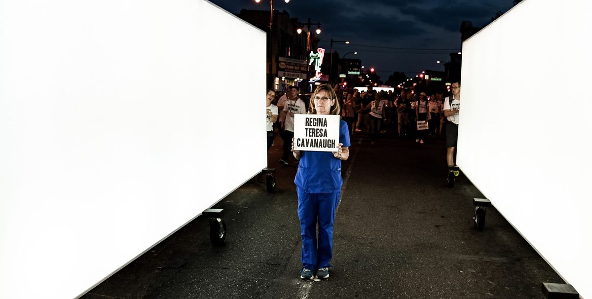 A health worker honours a victim of the 1918 flu pandemic as part of Spit Spreads Death: The Parade by Blast Theory on 28 September 2019 Photo by Tivern Turnbull