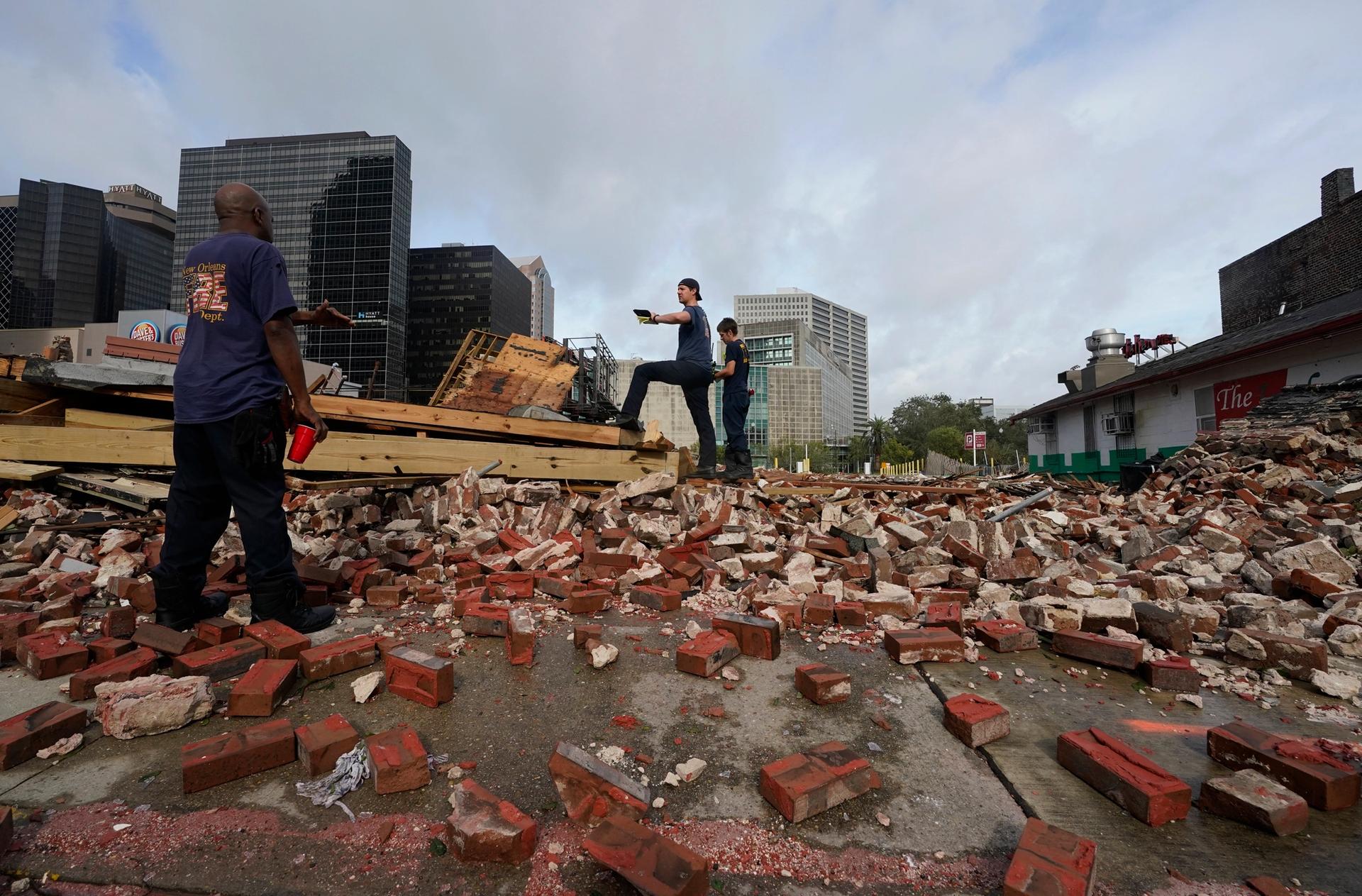 New Orleans firefighters assess damage as they look through debris after the Karnofsky Store building collapsed from the effects of Hurricane Ida AP Photo/Eric Gay