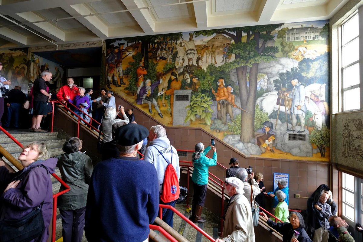 Visitors viewing a mural at George Washington High School in San Francisco at an open house in 2019 AP Photo/Eric Risberg