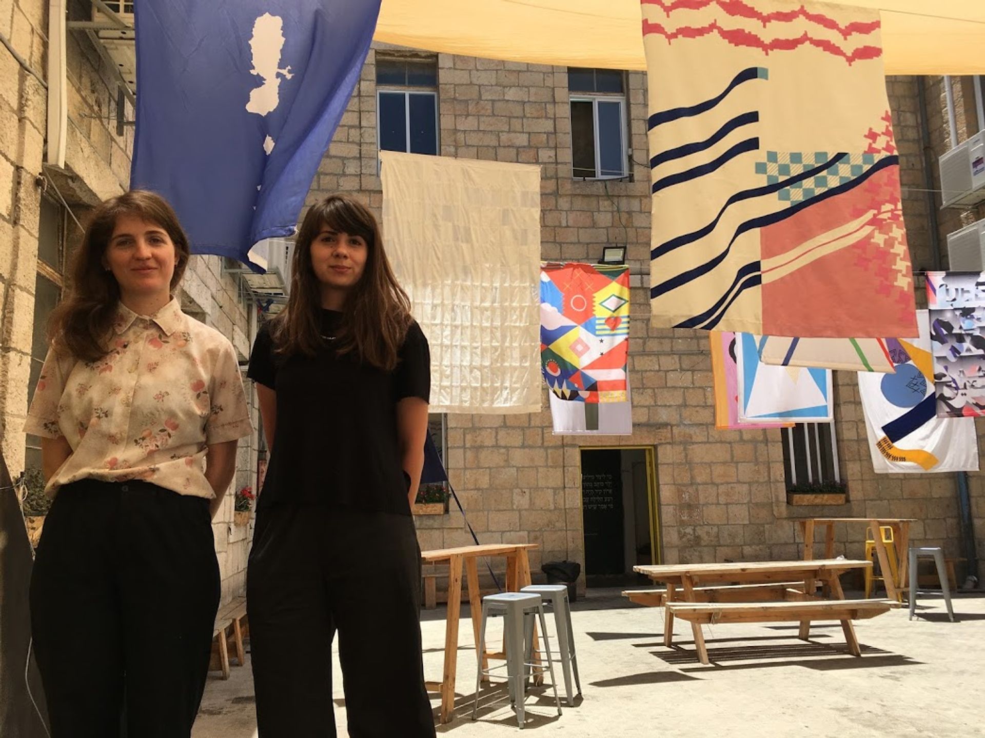 The curators Shy Ben Ari and Zohar Dvir at their exhibition of re-imagined Israeli flags at Alliance House in Jerusalem Lauren Gelfond