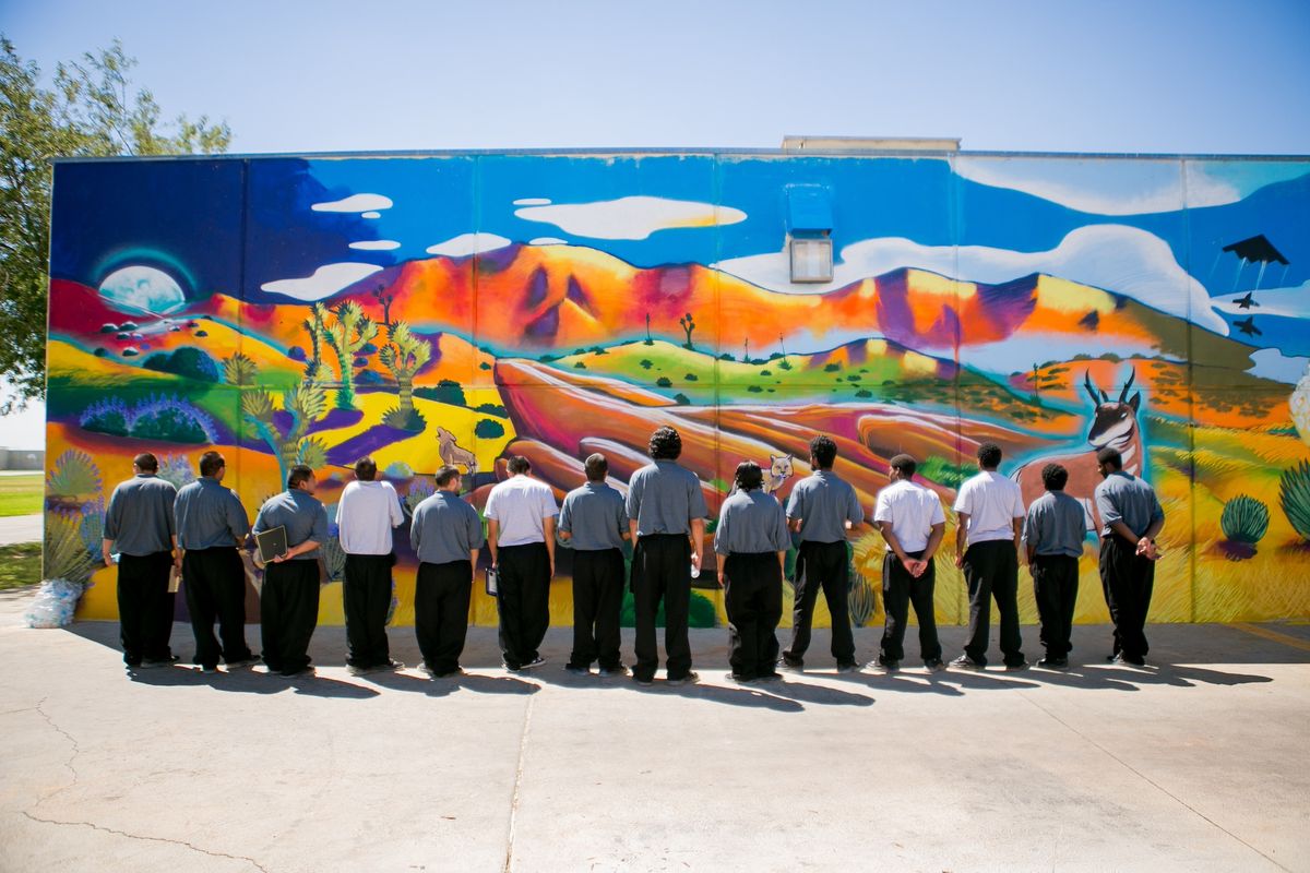 Youth admiring completed mural at Camp Onizuka with Armory Center for the Arts Image courtesy of Arts for Healing and Justice Network