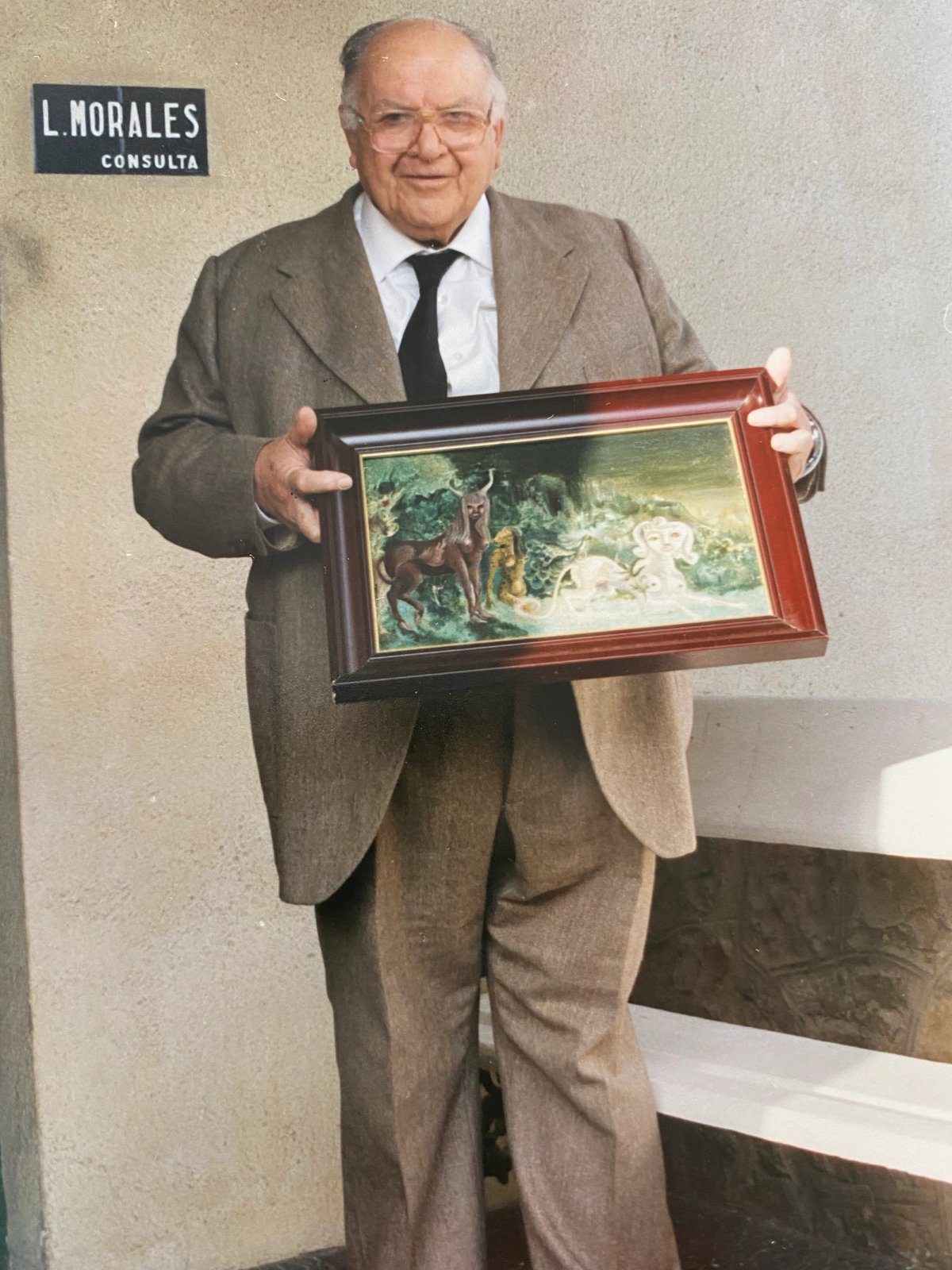 Leonora Carrington's psychiatrist Dr Luis Morales holding the painting she gave to him, Villa Pilar (1940)
Courtesy Joanna Moorhead