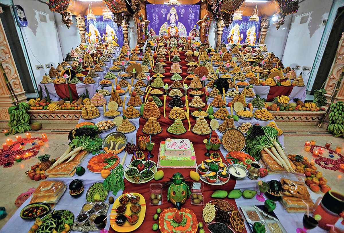 The universal need to give to God: food offerings in a temple in Ahmedabad, India, for the festival of Annakut during Diwali REUTERS/Alamy Stock Photo