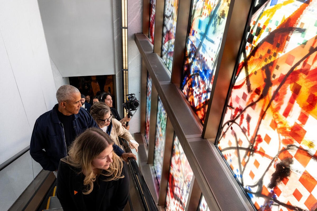 Former president Barack Obama (left) examines Julie Mehretu's window installation Uprising of the Sun at the Obama Presidential Center Courtesy The Obama Foundation