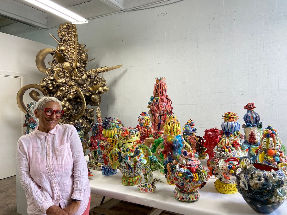 Charo Oquet in her studio with ceramic works and the sculpture Point of Joy Photo by Luna Palazzolo, courtesy the artist