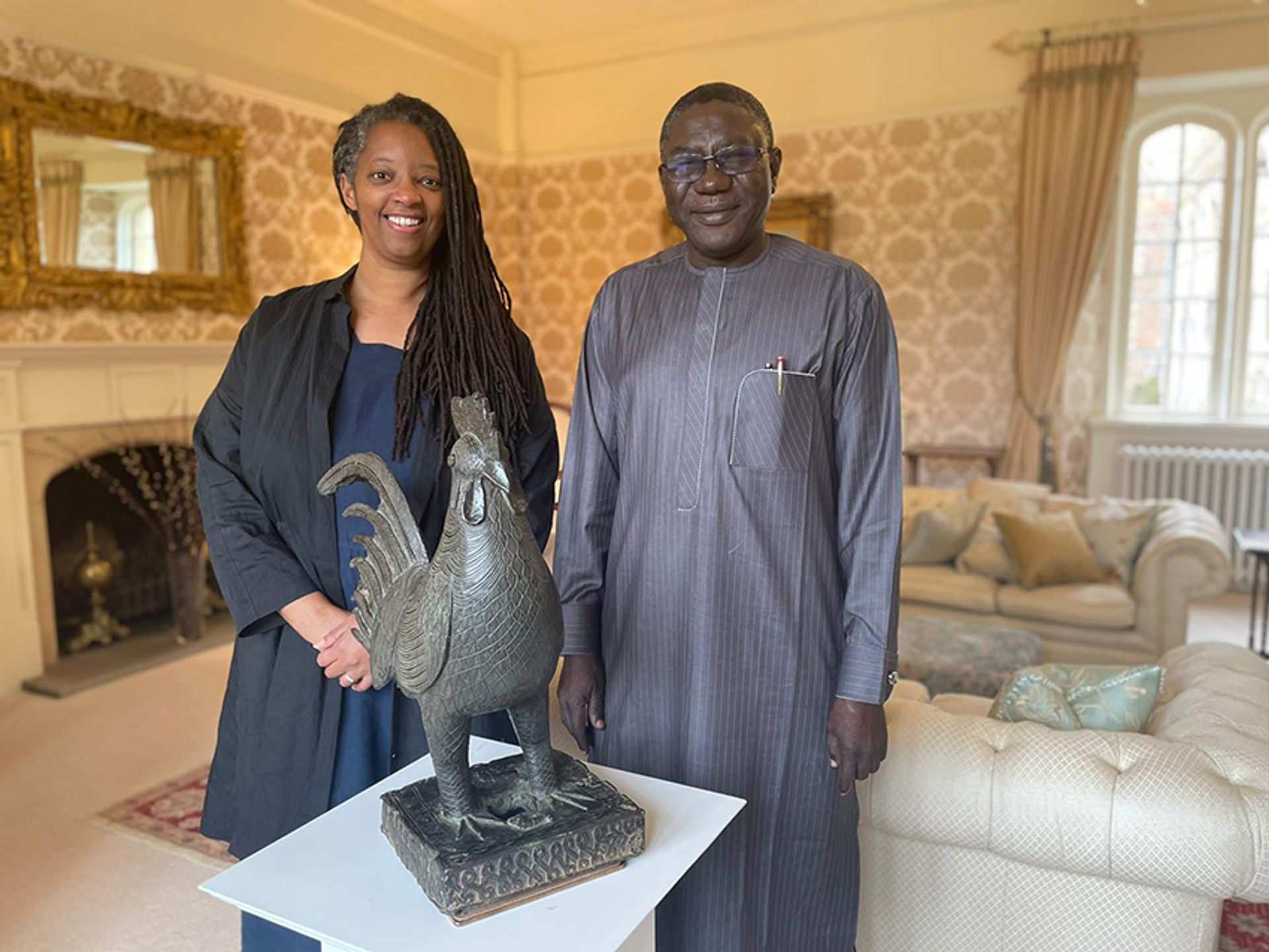 Sonita Alleyne, the master of Jesus College at the University of Cambridge, with Professor Abba Isa Tijani, the director general of the National Commission for Museums and Monuments of Nigeria, with the bronze cockerel Okukor Image: courtesy of Jesus College, Cambridge

