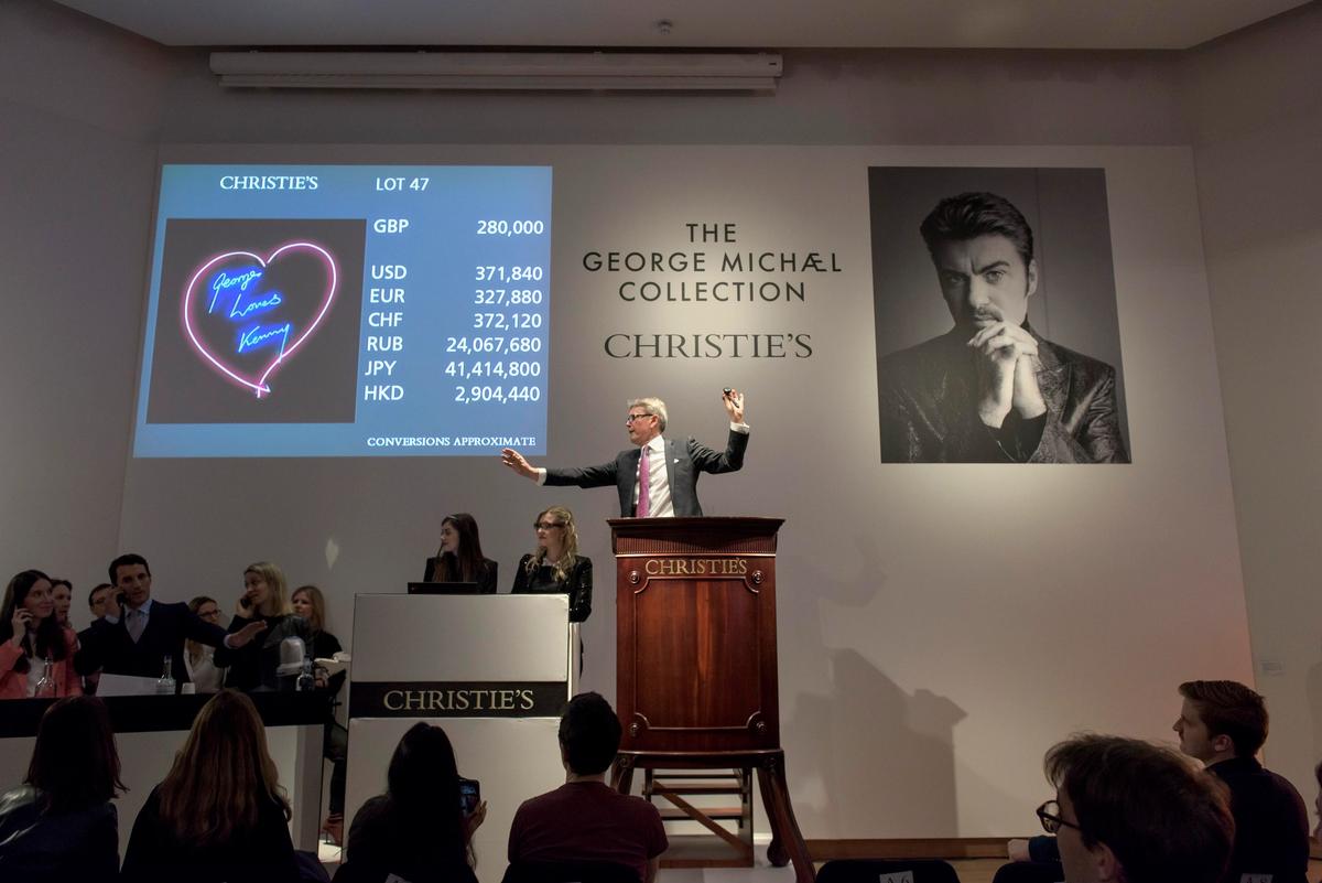 Auctioneer Jussi Pylkkänen slips a careless whisper to head of sale Christian Albu, who bids on Tracey Emin's neon on behalf of a client Courtesy of Christie's