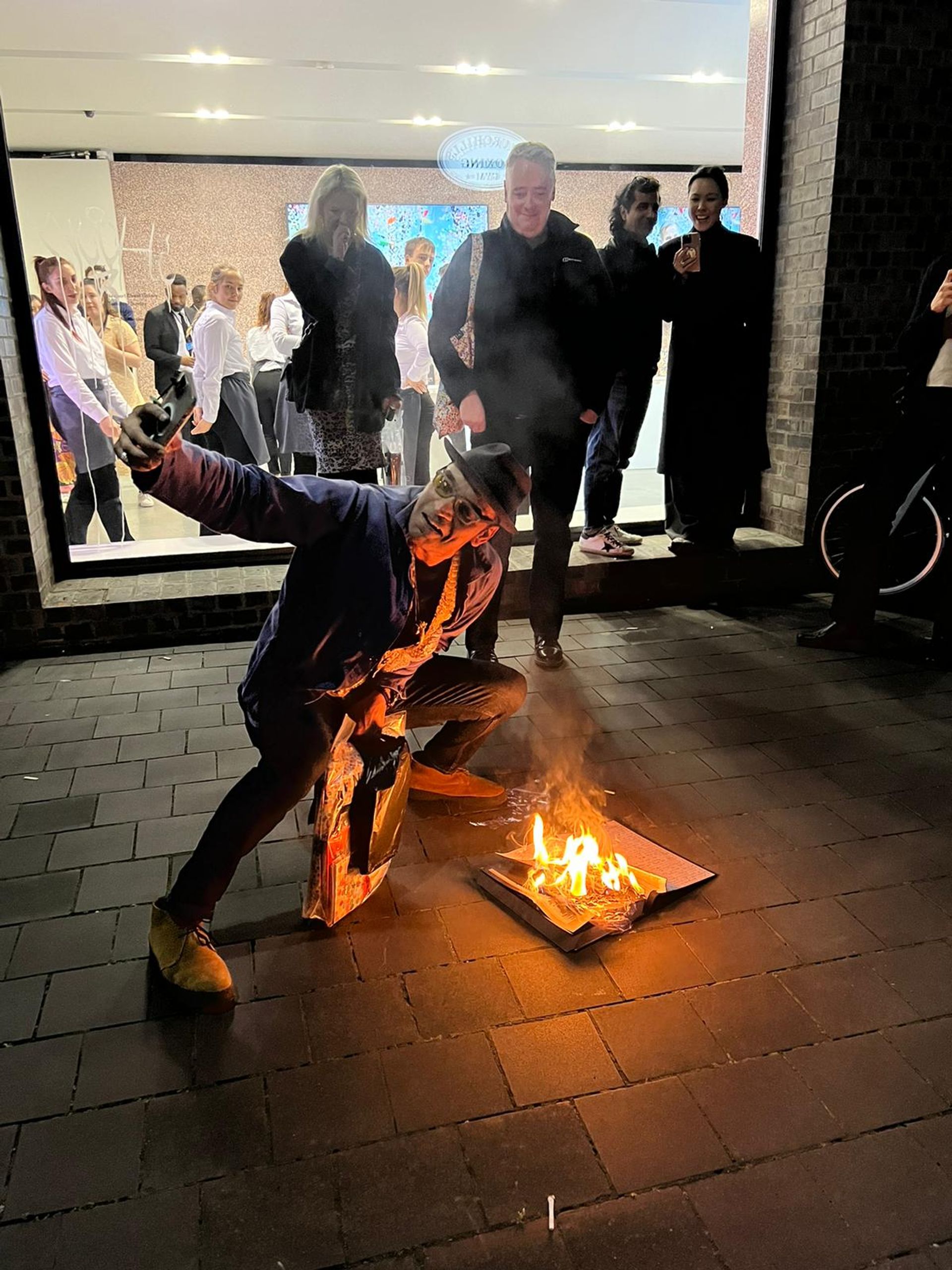 An artist set fire to a Damien Hirst exhibition catalogue outside Newport Street Gallery.

Photo: Amelia Webb