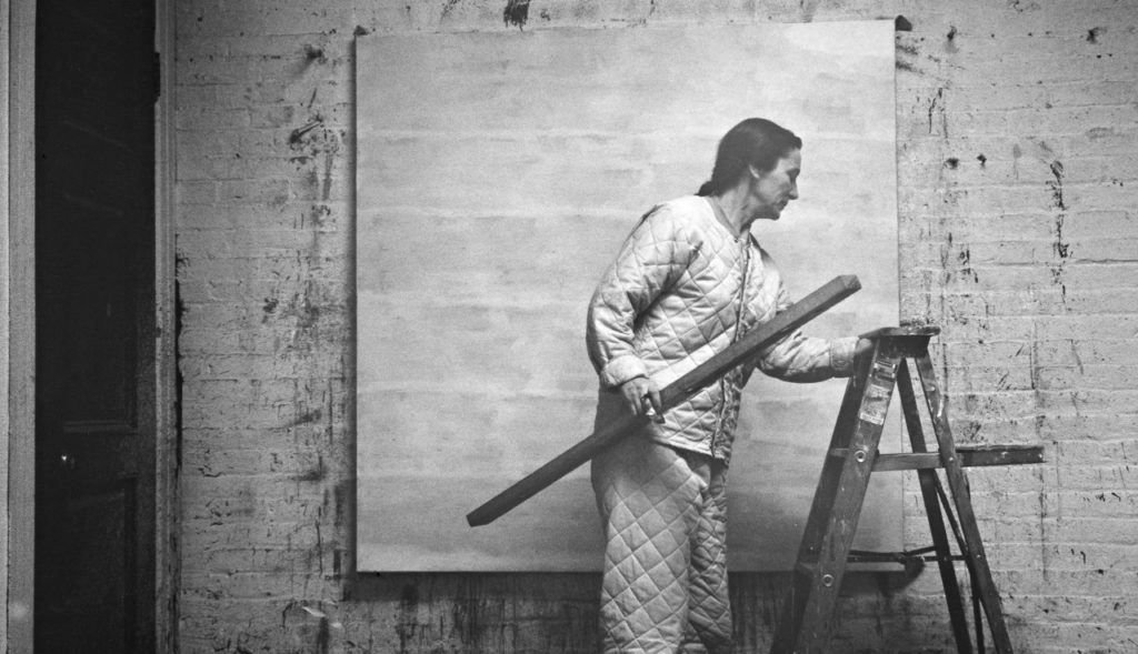 Agnes Martin in her studio. The 2016 lawsuit brought against Pace gallery and the artist's catalogue raisonné committee caused many  foundations to disband their authentication committees. Alexander Liberman Photography Archive, Getty Research Institute, Los Angeles. © J. Paul Getty Trust