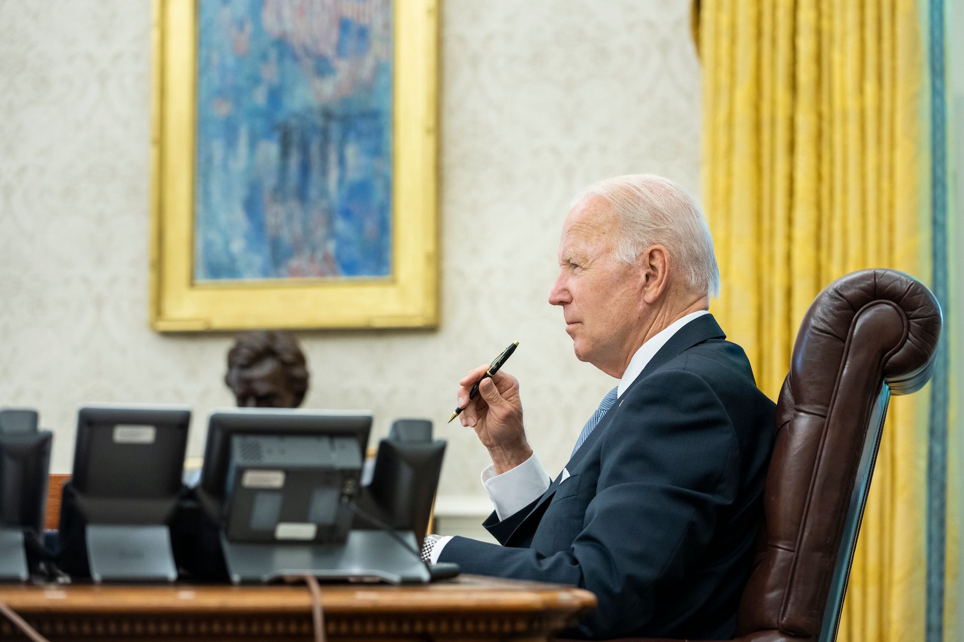 US President Joseph R. Biden in the Oval Office of the White House during a cabinet meeting in June 2022, with Childe Hassam's 1917 painting Avenue in the Rain hanging behind him Official White House photo by Erin Scott, via Flickr
