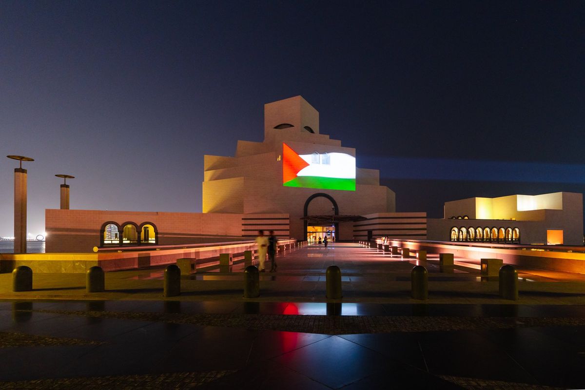 The exterior of the Museum of Islamic Art, one of the institutions run by Qatar Museums, featuring a projection of the Palestinian flag Photo via Sheikha Al Mayassa Al Thani/X