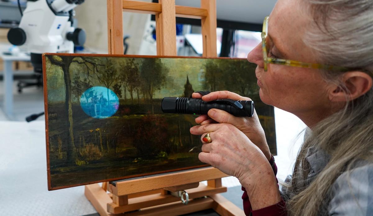 Conservator Marjan de Visser examining Van Gogh’s The Parsonage Garden at Nuenen in Spring (March 1884) 
Depot Boijmans van Beuningen. Photo: Denzel Feurich
