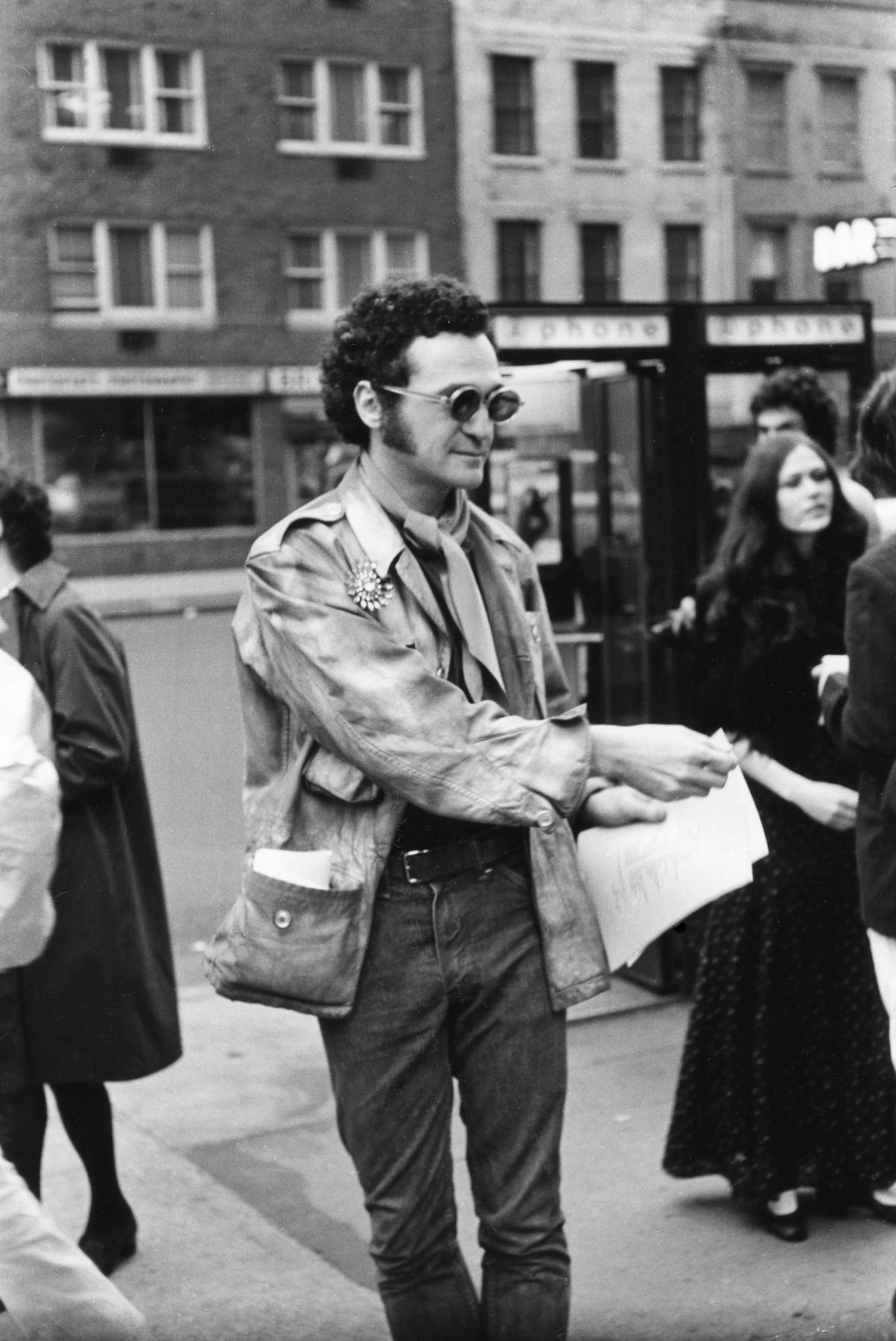 John Giorno passing out poems to passersby on Fifth Avenue, New York, in April 1969 Photo: Fred W. McDarrah/Getty Images