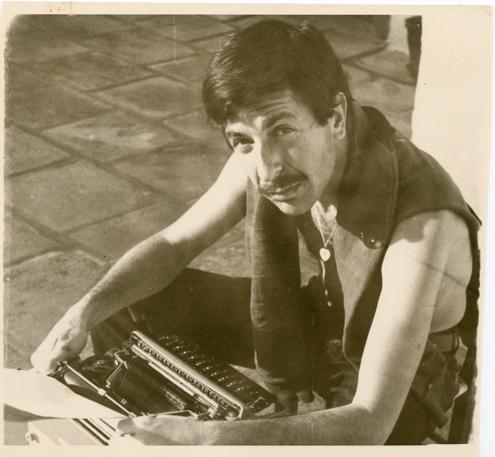 Unknown photographer, Cohen on Hydra [at typewriter], 1960s. © Leonard Cohen Family Trust.
