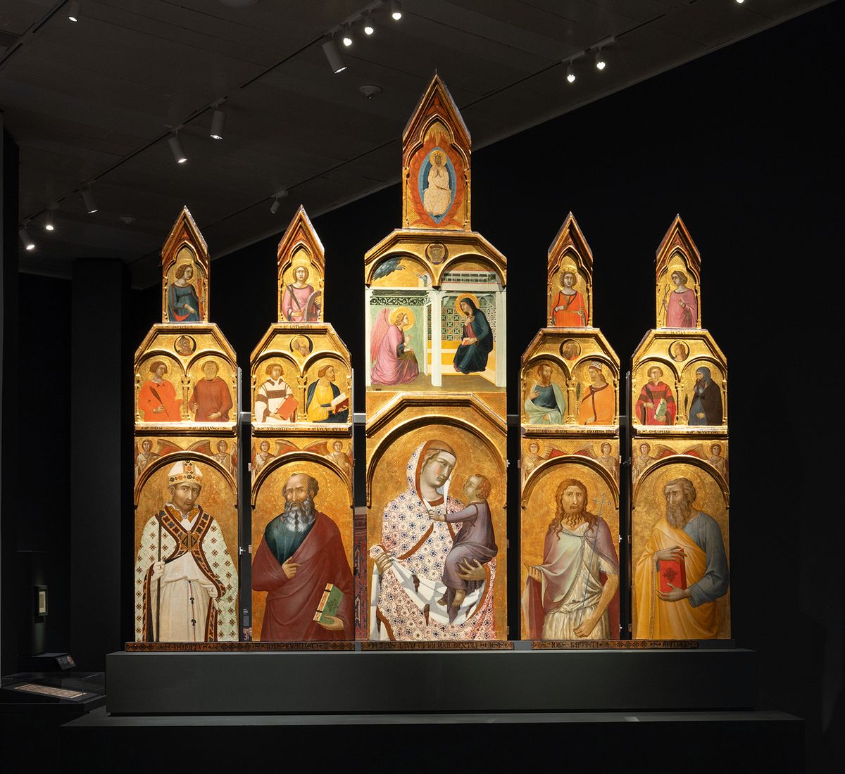 The exhibition space delicately spotlights works, including Pietro Lorenzetti's Tarlati Altarpiece, against "monastic" black walls
Photo: Eileen Travell