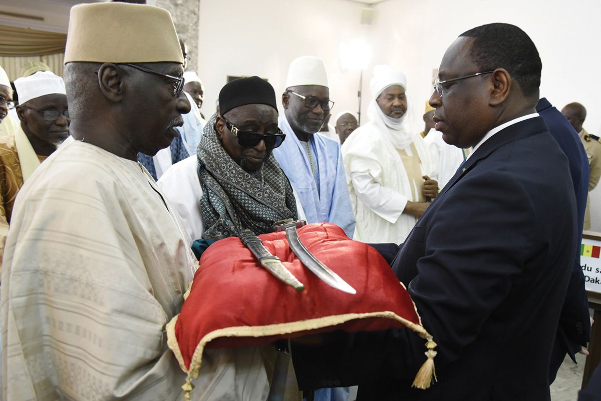 Senegal President Macky Sall, right, receives the sword El Hadj Omar Saidou Tall during a ceremony at the Palace of the Republic in Dakar, Senegal, on November 17, 2019 Photo: by Seyllour /AFP via Getty Images