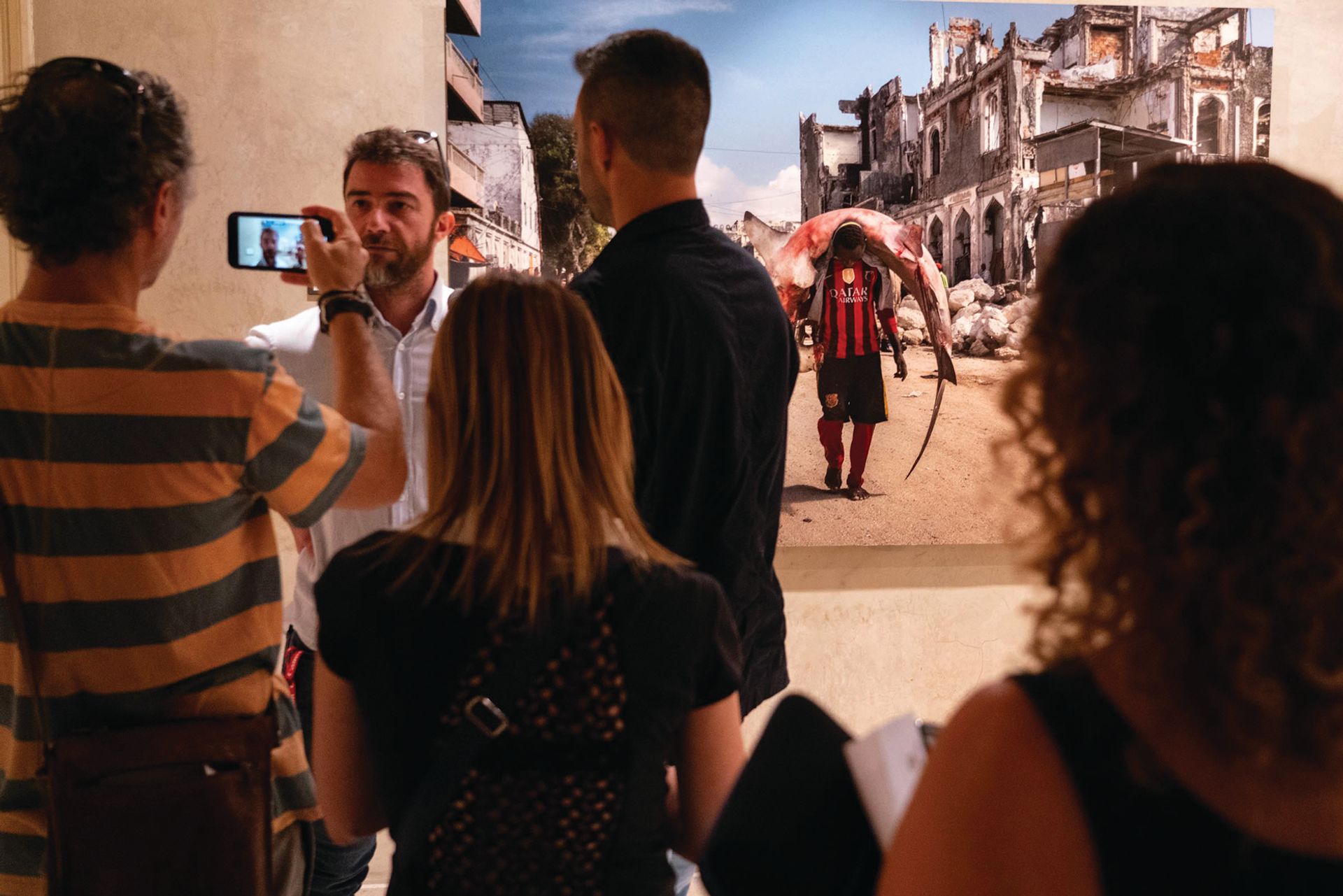 Italian photographer Marco Gualazzini at his exhibition Resilient at Palazzo Pigorini in Parma in 2019, showing his reportage of humanitarian crises in Africa from 2009 to 2018 © Città di Parma