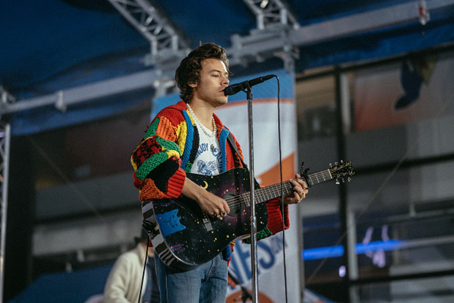 Harry Styles rehearsing for the Tonight Show in 2020, wearing a patchwork cardigan that has since found internet fame