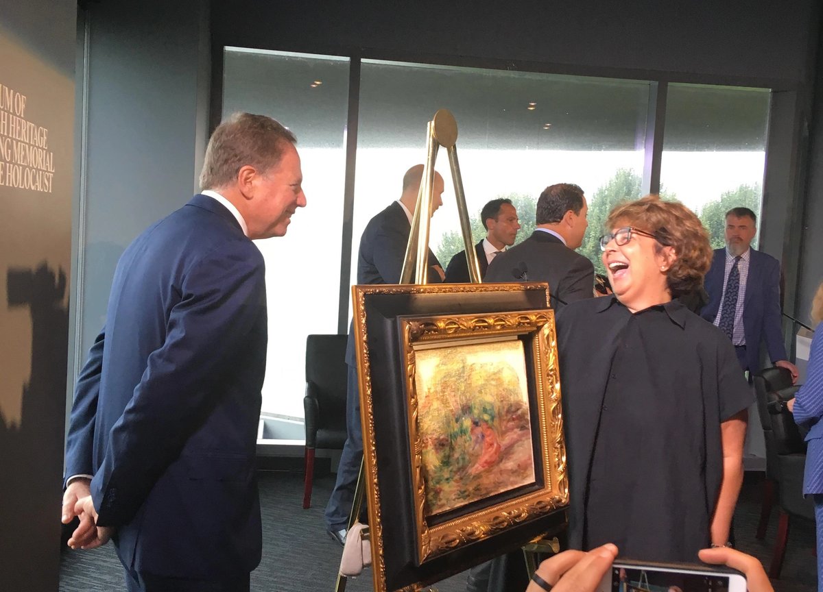 Sylvie Sulitzer, right, at a handover of Renoir's Two Women in a Garden (1919) with Geoffrey S. Berman, the US attorney for the Southern District of New York Elena Goukassian