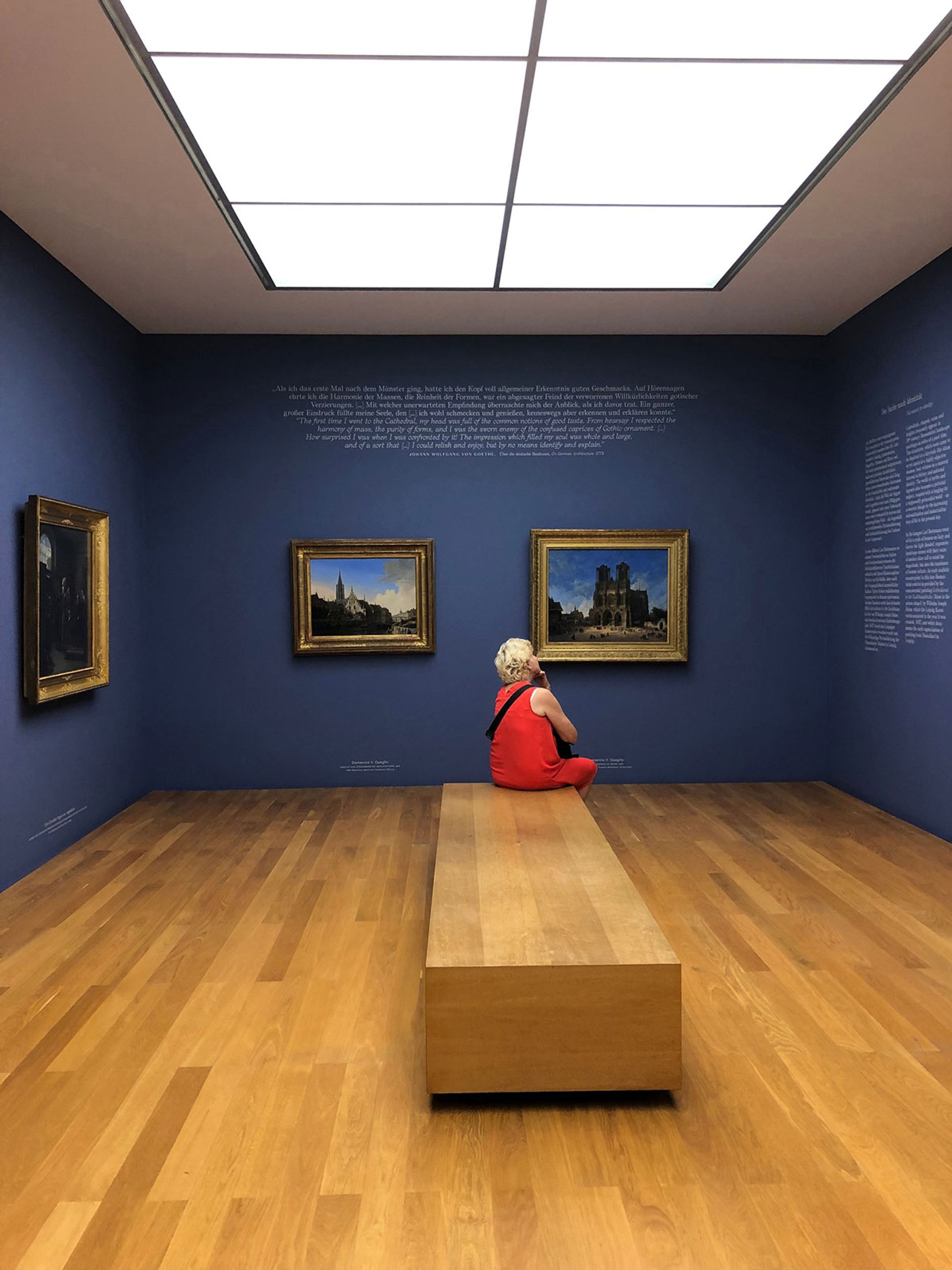A visitor in Museum der bildenden Kunste, Leipzig, reading the extensive text on offer Photograph by Dinah Casson