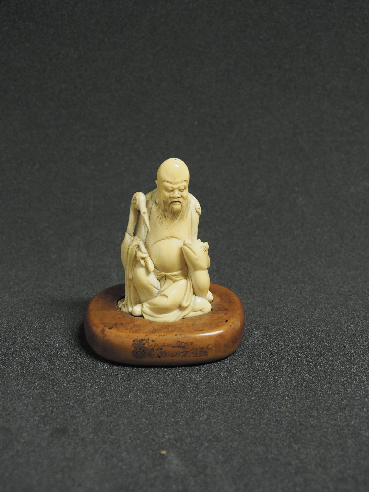 Carved ivory figure of Shouxing, the star god of longevity, with a deer and a crane The Trustees of the British Museum