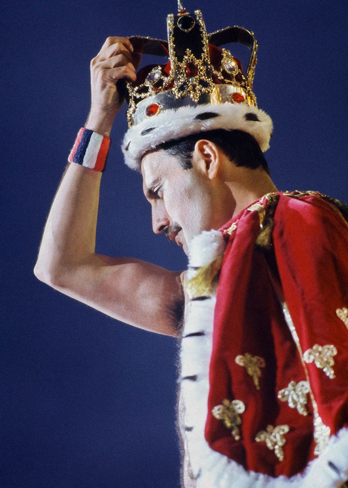 Freddie Mercury in his crown and cloak designed by Diana Moseley, worn on the Magic Tour in 1986

Photograph by Denis O’Regan