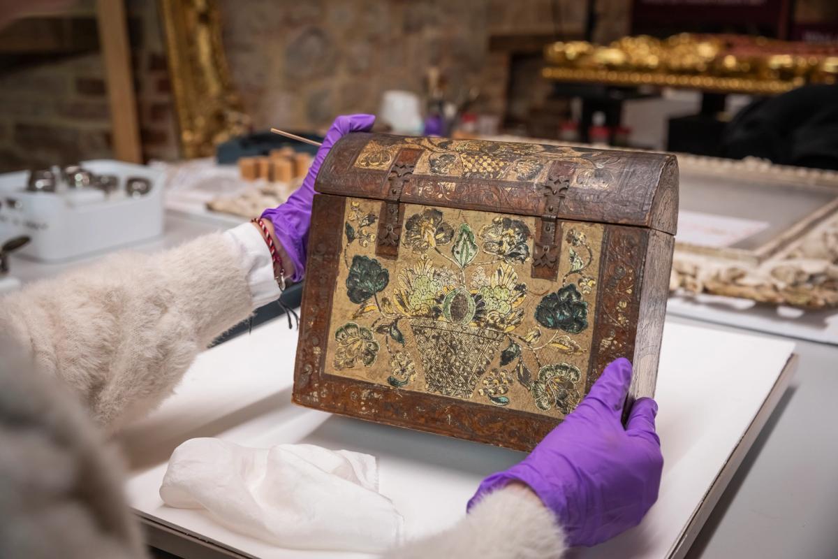 A conservator inspecting the Barniz de Pasto casket © National Trust Images. Photo: James Dobson