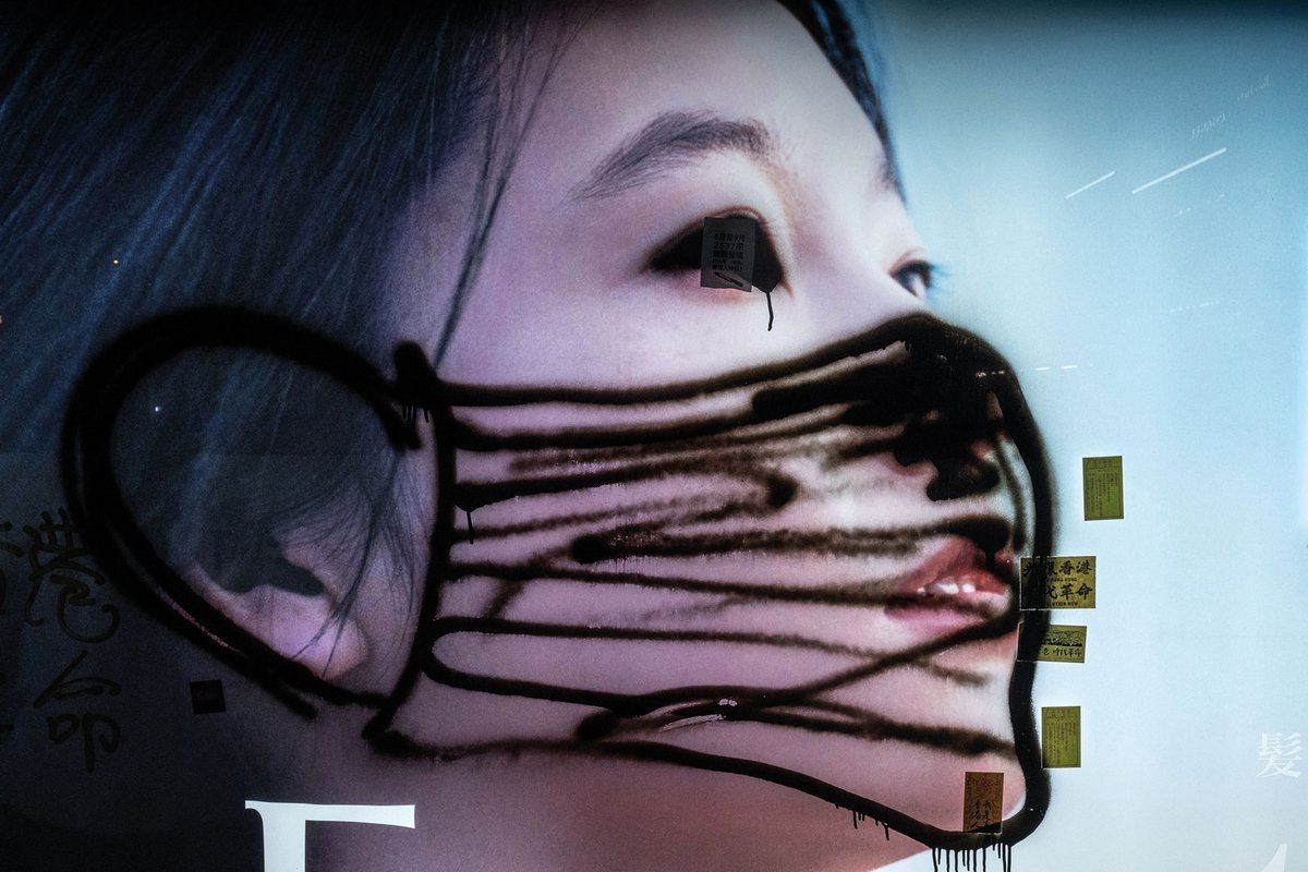 Graffiti on a poster in Hong Kong during demonstrations in December; Covid-19 has added to the woes of the region’s businesses and citizens © Justin Chin/Bloomberg via Getty