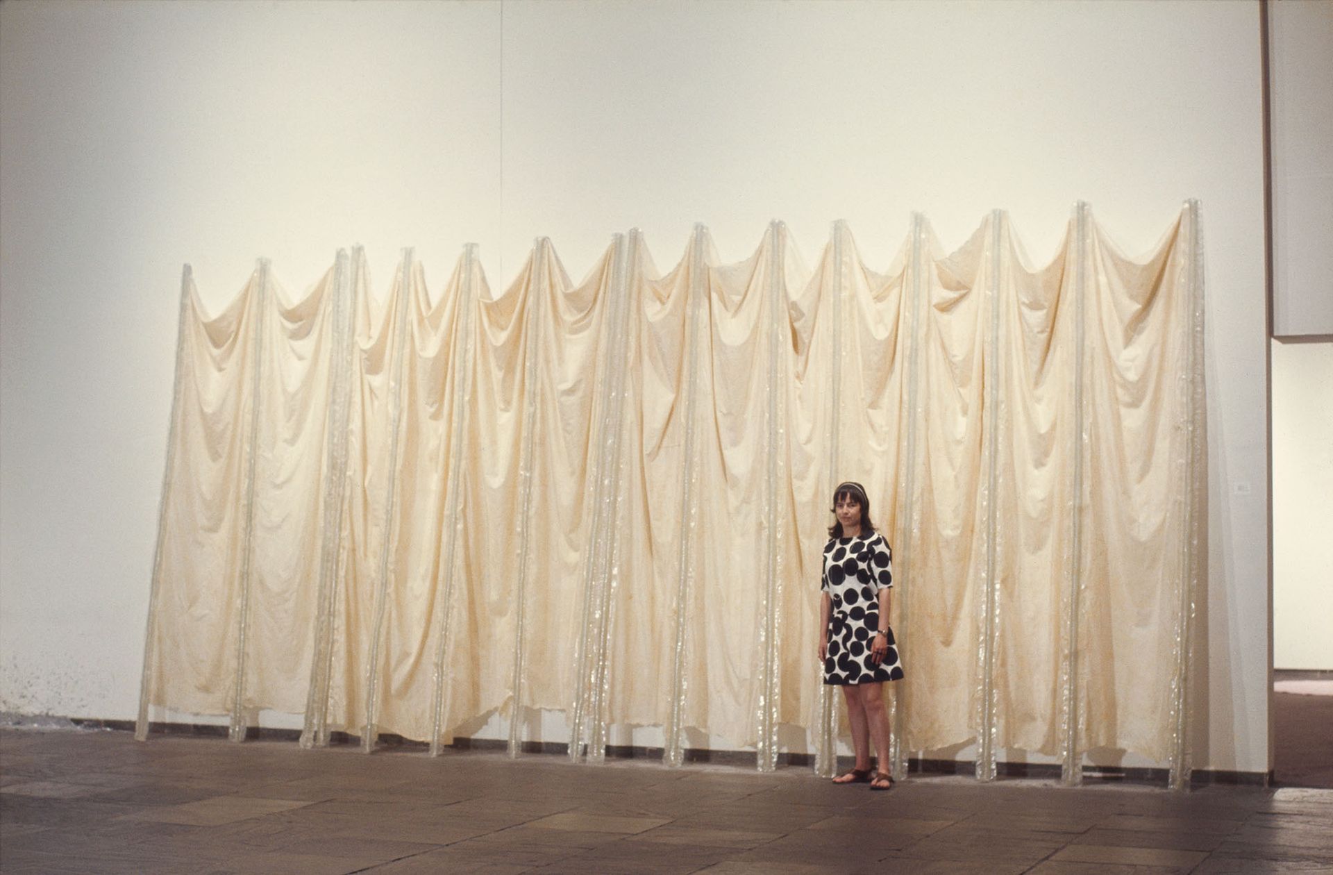 Eva Hesse in front of Expanded Expansion, 1969. Installation view, Anti-Illusion: Procedures/Materials, Whitney Museum of American Art, New York, 19 May-6 July 1969. Photo: Courtesy Frances Mulhall Achilles Library, Whitney Museum of American Art, New York