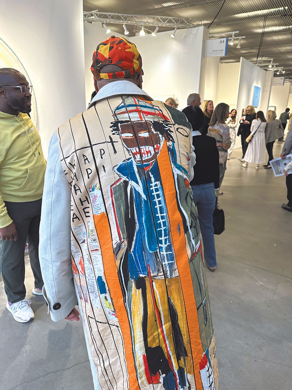 Collector Lyndon Barrois in his Basquiat-style coat among the stands at Frieze Photo: Gareth Harris