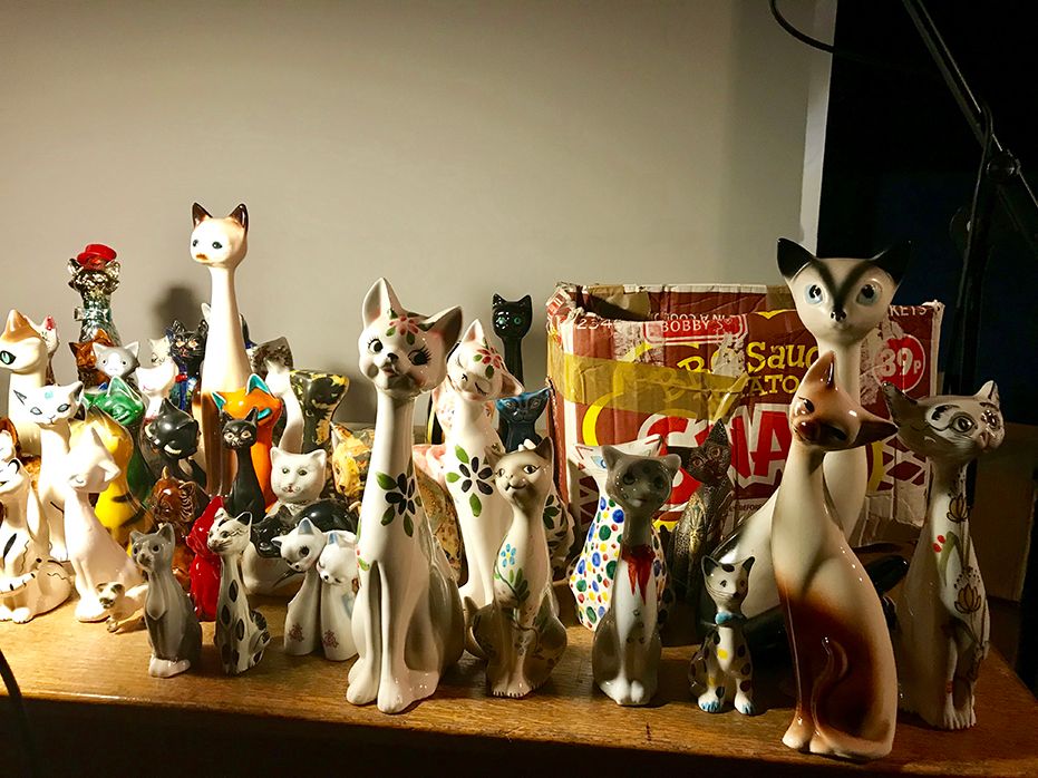 At the show, Holden unpacks some of the 300 ceramic cats that he inherited from his grandmother, who never herself owned a cat. Courtesy of Louisa Buck