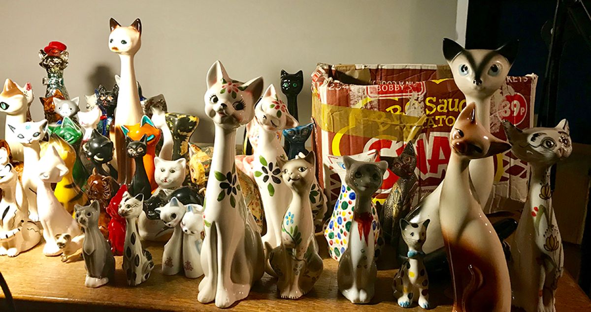 At the show, Holden unpacks some of the 300 ceramic cats that he inherited from his grandmother, who never herself owned a cat. Courtesy of Louisa Buck