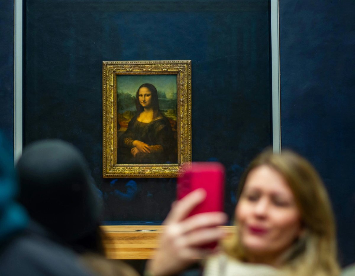 Snap happy: a visitor takes a selfie on their phone of in front of Leonardo da Vinci’s Mona Lisa (around 1503) Photo: Barry Talley (Unsplash)