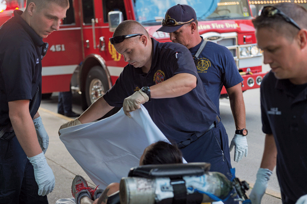 Paramedics in Charleston, West Virginia, tend to a woman suspected of overdosing Craig Hudson/Gazette-Mail photos