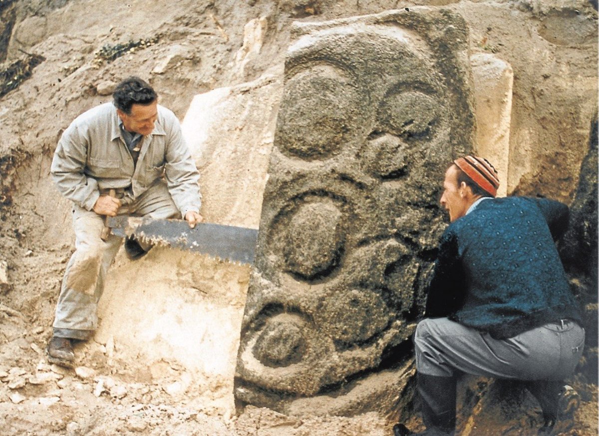 Workers remove the petroglyphs in the early 1960s; one carved slab was badly damaged in the process Luckman Collection, Tasmanian Archives