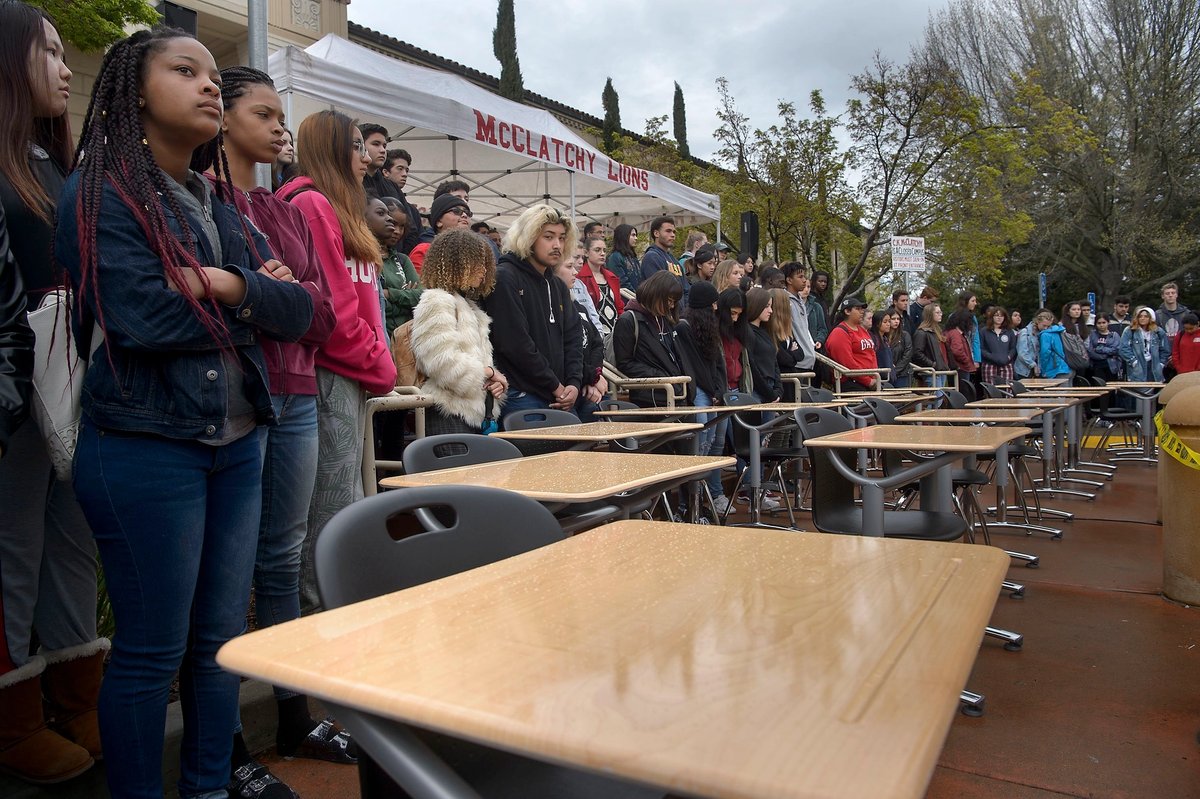 Students at McClatchy High School in Sacramento, California gather around 17 empty desks representing the shooting victims from Marjory Stoneman Douglas High School in Parkland, Florida Randall Benton/The Sacramento Bee via AP