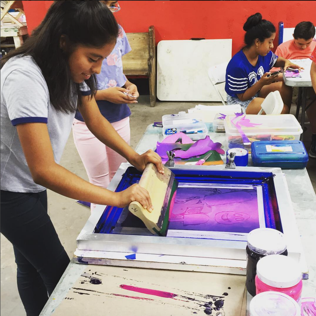 Students from the Heart of Los Angeles after-school programme learn to make prints at Self Help Graphics & Art
Courtesy Self Help Graphics & Art