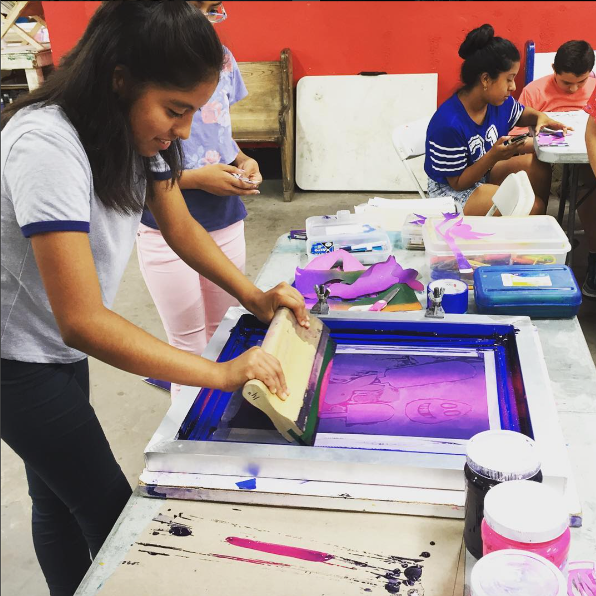 Students from the Heart of Los Angeles after-school programme learn to make prints at Self Help Graphics & Art
Courtesy Self Help Graphics & Art