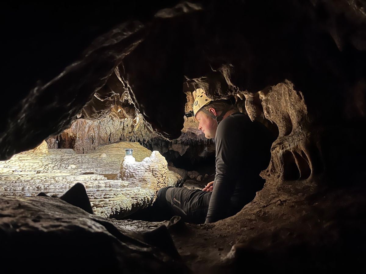 Daniel H. James installs a drip rate monitor upon a flowstone in Grutas Tzabnah (Yucatán, Mexico) as part of the wider cave monitoring campaign. Photo: Sebastian Breitenbach, 2022