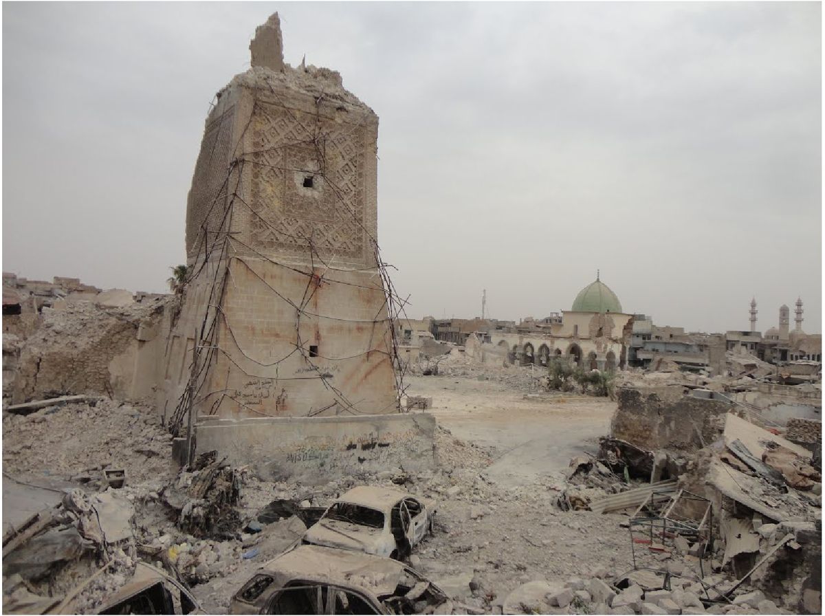 Scorched vehicles at the foot of the destroyed Al-Hadba' Minaret in Mosul, Iraq Courtesy of the World Monuments Fund