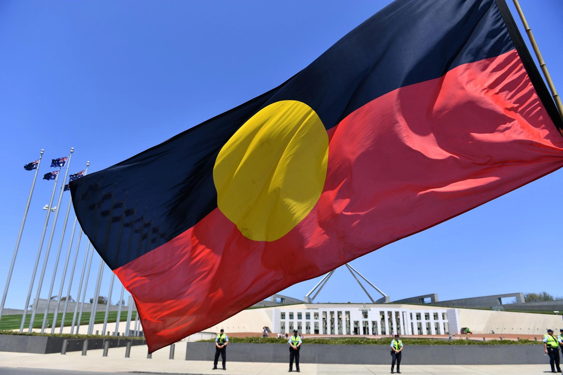 The Aboriginal flag flies at Parliament House in Canberra, Australia. MICK TSIKAS/EPA-EFE/Shutterstock