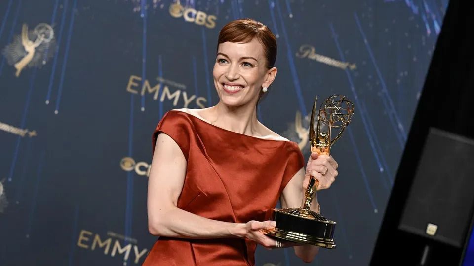 Britt Lower holding the Emmy for Lead Actress in a Drama Series for her role in Severance.