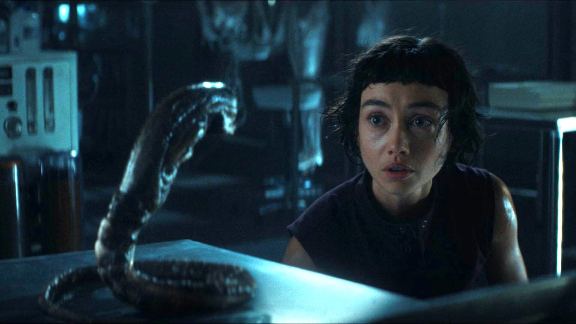 Wendy looking at a baby Xenomorph on a lab table